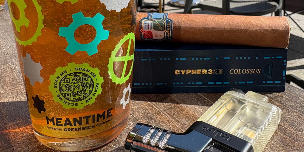 The Cyper3311 Colossus resting on its box in the sun next to a Meantime beer.