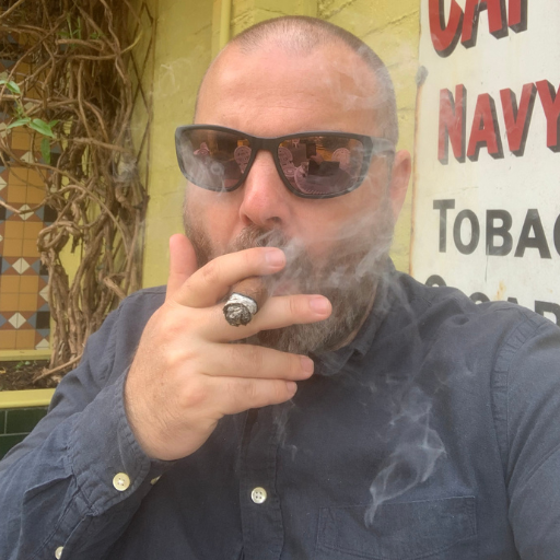 Sam smoking a cigar - Cigars Near Me